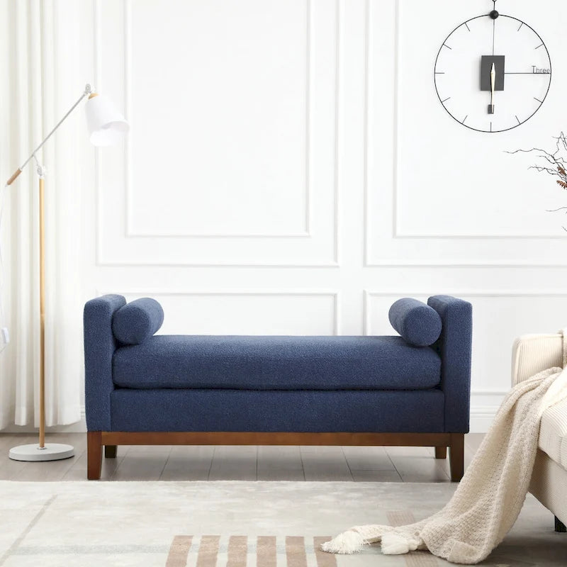 Banc/pouf élégant de 53,5 cm de large, capitonné, avec pieds en bois et coussins cylindriques, idéal pour le pied de lit, la chambre, le salon ou l'entrée.