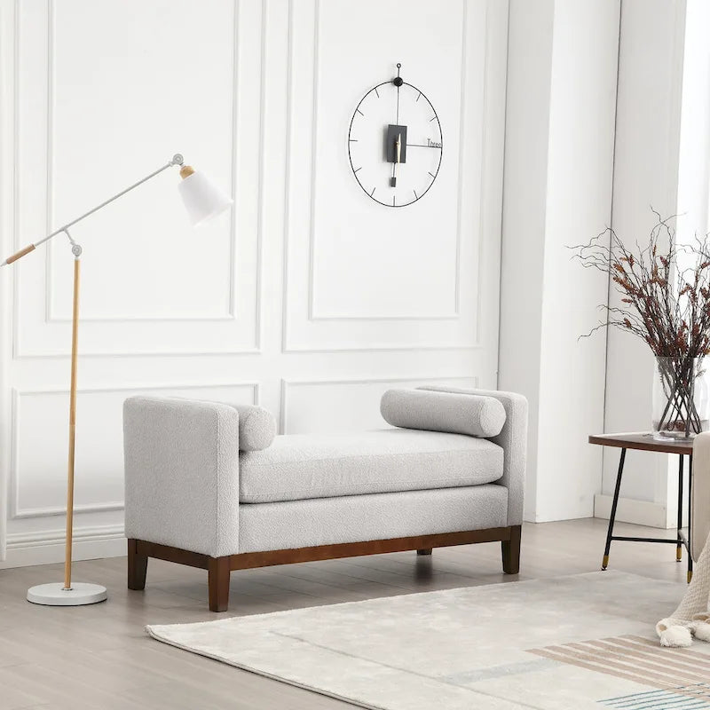 Banc/pouf élégant de 53,5 cm de large, capitonné, avec pieds en bois et coussins cylindriques, idéal pour le pied de lit, la chambre, le salon ou l'entrée.