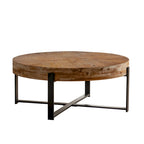 Table basse ronde moderne rétro avec plateau en bois de sapin et piètement croisé noir, idéale pour le salon.