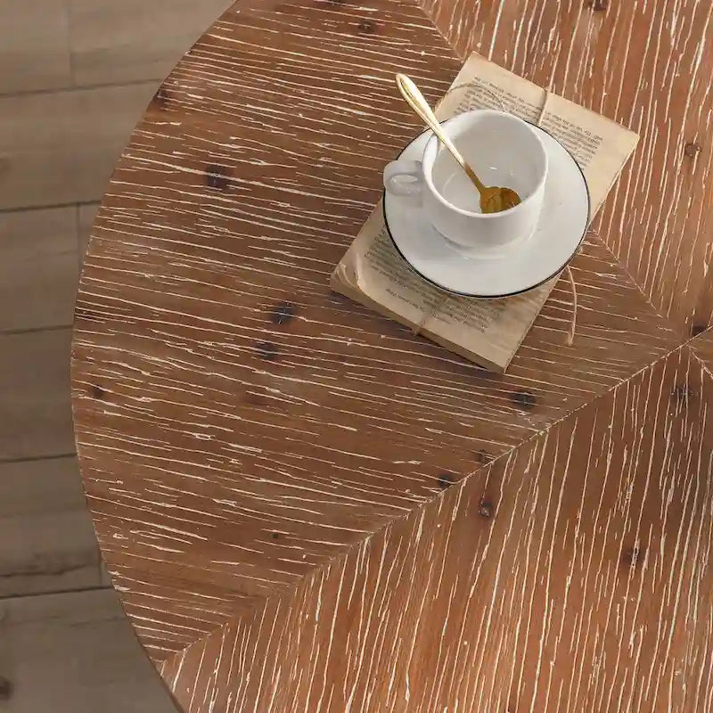 Table basse ronde moderne rétro avec plateau en bois de sapin et piètement croisé noir, idéale pour le salon.