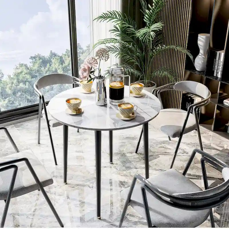 Table de salle à manger ronde avec plateau en marbre et pieds en métal, idéale pour la salle à manger ou la cuisine.