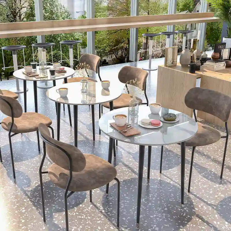 Table de salle à manger ronde avec plateau en marbre et pieds en métal, idéale pour la salle à manger ou la cuisine.