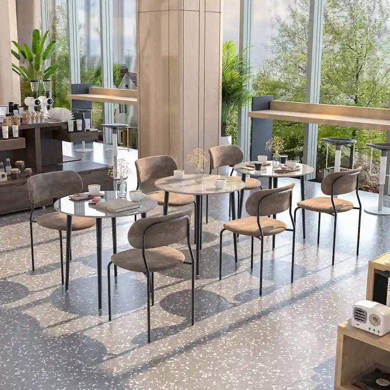 Table de salle à manger ronde avec plateau en marbre et pieds en métal, idéale pour la salle à manger ou la cuisine.