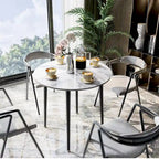 Table de salle à manger ronde avec plateau en marbre et pieds en métal, idéale pour la salle à manger ou la cuisine.